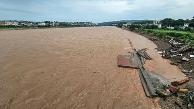 In an aerial view, the swollen Tawi river is seen inundate its bank as it continues to flow with a rise in its water levels after Jammu experienced incessant rain since Monday. (Shilpa Thakur/ANI) In an aerial view, the swollen Tawi river is seen inundate its bank as it continues to flow with a rise in its water levels after Jammu experienced incessant rain since Monday. (Shilpa Thakur/ANI)