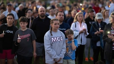 Community members gathered at Lynnhurst Park on August 27 to mourn the dead and pray for the wounded after the tragic shooting at Annunciation Catholic School. (Photo by SCOTT OLSON / GETTY IMAGES NORTH AMERICA / Getty Images via AFP) (Getty Images via AFP) Community members gathered at Lynnhurst Park on August 27 to mourn the dead and pray for the wounded after the tragic shooting at Annunciation Catholic School. (Photo by SCOTT OLSON / GETTY IMAGES NORTH AMERICA / Getty Images via AFP) (Getty Images via AFP)