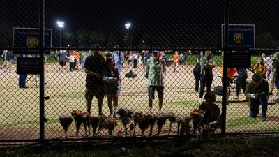 Mourners placed flowers along a fence at Lynnhurst Park during a vigil held after the Annunciation Church shooting on August 27. REUTERS/Tim Evans (REUTERS)