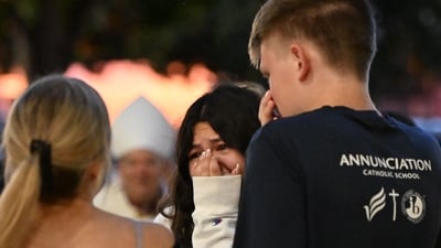 Mourners gather during a vigil at Academy of Holy Angels in Richfield, Minnesota, for the victims of a mass shooting at Annunciation Catholic Church and School in Minneapolis, where two people were killed and 17 injured by a shooter on August 27, 2025. (Photo by Tom BAKER / AFP) (AFP) Mourners gather during a vigil at Academy of Holy Angels in Richfield, Minnesota, for the victims of a mass shooting at Annunciation Catholic Church and School in Minneapolis, where two people were killed and 17 injured by a shooter on August 27, 2025. (Photo by Tom BAKER / AFP) (AFP)