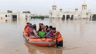 A Punjab Emergency Service boat rescues people from the flooded area of the Kartarpur Sahib Corridor complex, which runs along the India-Pakistan border in Kartarpur, Pakistan. (AFP) A Punjab Emergency Service boat rescues people from the flooded area of the Kartarpur Sahib Corridor complex, which runs along the India-Pakistan border in Kartarpur, Pakistan. (AFP)