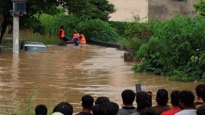 Relief personnel carry out rescue ops in an inundated area in Sialkot, located in Pakistan's Punjab province, after the area was hit by floods and heavy downpour. (Akhtar Soomro/Reuters)