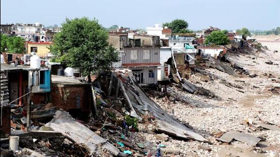 Damaged houses along the banks of the Tawi river a day after it was flowing in spate due to heavy rainfall in Jammu on Thursday. (PTI Photo)
