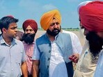 Cabinet minister Hardeep Singh Mundian and deputy commissioner Himanshu Jain (left) at Sasrali colony in Ludhiana on Thursday. (HT Photo)