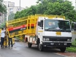 Traffic police carrying a traffic barrier for route diversion. (Sunil Ghosh/HT Photo) Traffic police carrying a traffic barrier for route diversion. (Sunil Ghosh/HT Photo)
