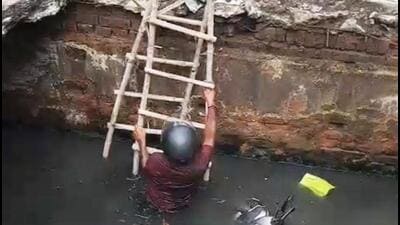 A man on a two-wheeler fell in an open drain in Indirapuram on Thursday. (HT PHOTO)