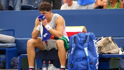 Ben Shelton, of the United States, sits on his bench after retiring in the US Open (AP) Ben Shelton, of the United States, sits on his bench after retiring in the US Open (AP)