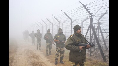 Border Security Force (BSF) personnel stand guard along the India-Pakistan border fence (File) Border Security Force (BSF) personnel stand guard along the India-Pakistan border fence (File)