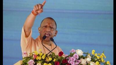 Chief minister Yogi Adityanath addresses the gathering during inauguration and foundation-laying ceremony for various development projects, in Pratapgarh, Friday. (PTI Photo)
