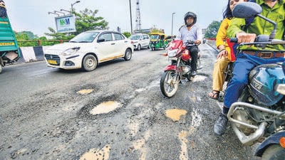Commuters move amid the broken patches of the flyover after the Friday rain. (RAJ K RAJ /HT PHOTO) Commuters move amid the broken patches of the flyover after the Friday rain. (RAJ K RAJ /HT PHOTO)