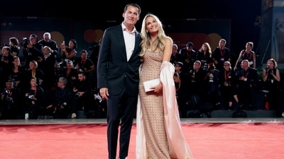Scott Stuber and Molly Sims pose on the red carpet for the screening of Jay Kelly. (REUTERS)