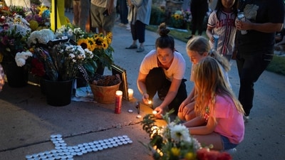Jen Labanowski, her daughter Lucy (R), and her daughter's friend Cece Degnan (C), light candles at a memorial for victims of yesterday's shooting in front of Annunciation Catholic Church on August 28, 2025 in Minneapolis, Minnesota. (Photo by SCOTT OLSON / GETTY IMAGES NORTH AMERICA / Getty Images via AFP) (Getty Images via AFP) Jen Labanowski, her daughter Lucy (R), and her daughter's friend Cece Degnan (C), light candles at a memorial for victims of yesterday's shooting in front of Annunciation Catholic Church on August 28, 2025 in Minneapolis, Minnesota. (Photo by SCOTT OLSON / GETTY IMAGES NORTH AMERICA / Getty Images via AFP) (Getty Images via AFP)
