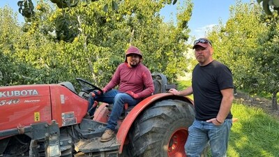 Blaine Smith (standing) and H-2A employee Oscar Jimenez at Mr. Smith’s farm. Blaine Smith (standing) and H-2A employee Oscar Jimenez at Mr. Smith’s farm.