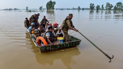 Indian Army personnel rescue local residents using a boat to evacuate through the flooded waters of the Beas River in Kapurthala. (AFP) Indian Army personnel rescue local residents using a boat to evacuate through the flooded waters of the Beas River in Kapurthala. (AFP)