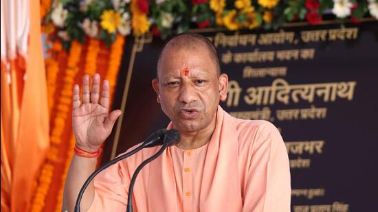 Uttar Pradesh chief minister Yogi Adityanath addressing a gathering after laying the foundation stone of the State Election Commission building in Lucknow on Friday. (HT Photo)