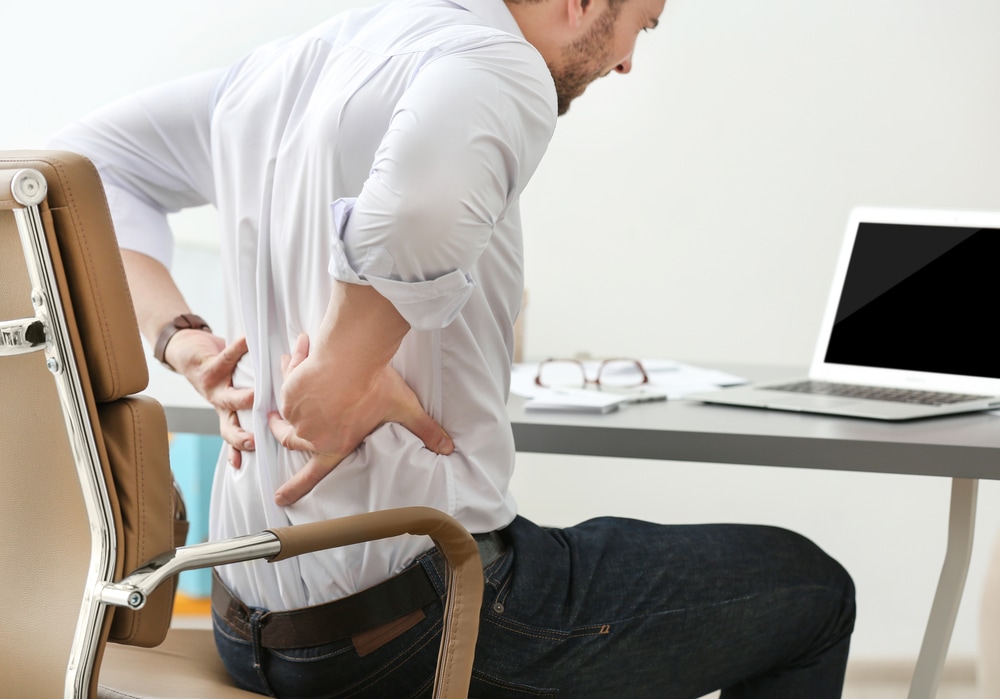 Lower back usually hurts when you stay seated at your desk for long hours at work. (Shutterstock) Lower back usually hurts when you stay seated at your desk for long hours at work. (Shutterstock)