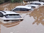 Cars submerged in floodwaters that entered residential societies in Himmatnagar, Gujarat. Cars submerged in floodwaters that entered residential societies in Himmatnagar, Gujarat.