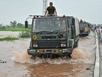 Indian Army personnel on their trucks arrive to rescue flood victims stranded in floodwaters after a rise in water level of the Ravi river at a village near Ajnala, Amritsar on Friday. (AFP) Indian Army personnel on their trucks arrive to rescue flood victims stranded in floodwaters after a rise in water level of the Ravi river at a village near Ajnala, Amritsar on Friday. (AFP)