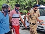 The accused (centre) in police custody on Friday. (HT Photo) The accused (centre) in police custody on Friday. (HT Photo)