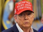 US President Donald Trump wears a 'Trump Was Right About Everything!' hat as he makes an announcement in the Oval Office at the White House in Washington, D.C.