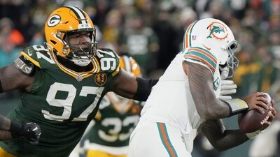 Kenny Clark (97 in Green Bay Packers kit) sacks Miami Dolphins quarterback Tua Tagovailoa. (AP) Kenny Clark (97 in Green Bay Packers kit) sacks Miami Dolphins quarterback Tua Tagovailoa. (AP)