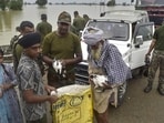 Army personnel and locals carry rescued rabbits at a flood-affected village in Kapurthala, Punjab on Saturday. (PTI)