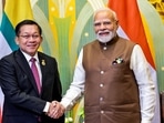 Prime Minister Narendra Modi and Myanmar's junta chief Min Aung Hlaing shake hands during a bilateral meeting on the sidelines of the Shanghai Cooperation Organisation (SCO) summit in Tianjin. 