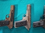 Police teams recovered three .30-bore country-made pistols from the accused. (HT Photo)