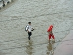 People wading through a waterlogged road in UP's Ghaziabad on Friday