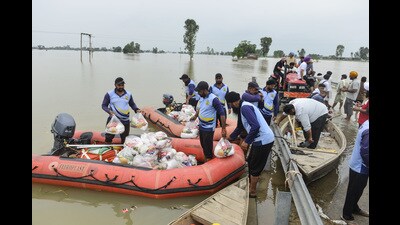 SDRF personnel load flood relief material to distribute to stranded people, in Kapurthala. (ANI)