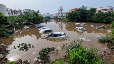 Vehicles submerged in the floodwater at a waterlogged area after heavy rainfall, at Himmatnagar, in Sabarkantha district of Gujarat (PTI) Vehicles submerged in the floodwater at a waterlogged area after heavy rainfall, at Himmatnagar, in Sabarkantha district of Gujarat (PTI)