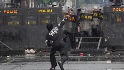 Police officers cover themselves with riot shields as a protester throws rock at them during a protest against lavish allowances given to parliament members, outside the parliament in Jakarta, Indonesia, Sunday, Aug. 31, 2025. (AP) Police officers cover themselves with riot shields as a protester throws rock at them during a protest against lavish allowances given to parliament members, outside the parliament in Jakarta, Indonesia, Sunday, Aug. 31, 2025. (AP)