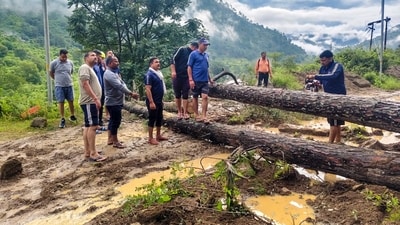 Army personnel cut uprooted trees blocking the Tharali-Karnprayag National Highway after heavy rainfall, near Kulsari, in Uttarakhand's Chamoli district, (PTI) Army personnel cut uprooted trees blocking the Tharali-Karnprayag National Highway after heavy rainfall, near Kulsari, in Uttarakhand's Chamoli district, (PTI)