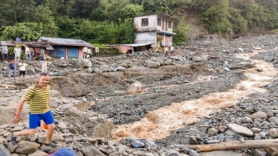 People in Himachal's Mandi move through debris and boulders washed along flash floods due to heavy rainfall (PTI) People in Himachal's Mandi move through debris and boulders washed along flash floods due to heavy rainfall (PTI)