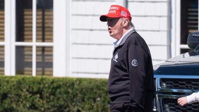 President Donald Trump walks at the Trump National Golf Club in Sterling, Va., Saturday. (AP)
