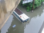 A bus was partially submerged in the middle of the road after severe water logging due to heavy rainfall, in Jalandhar on Monday. (ANI)