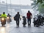 Commuters wade their way amid heavy rain. Commuters wade their way amid heavy rain.