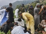 Civil defence workers, locals, and army soldiers prepare to evacuate injured victims of an earthquake that killed hundreds and destroyed numerous villages in eastern Afghanistan, in Mazar Dara, Kunar province, on Sept. 1 (AP) Civil defence workers, locals, and army soldiers prepare to evacuate injured victims of an earthquake that killed hundreds and destroyed numerous villages in eastern Afghanistan, in Mazar Dara, Kunar province, on Sept. 1 (AP)