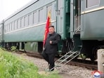 North Korean leader Kim Jong Un steps off a train during a visit to a flood-affected area near the border with China, in North Pyongan Province, North Korea.