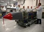 Britain's Defence Secretary John Healey (C) and his French counterpart, Sebastien Lecornu (2L), are shown Storm Shadow missiles during a visit