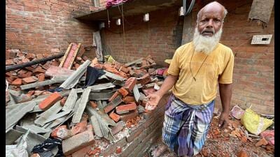 Aziz, 60, a daily-wager, shows his house destroyed by the blast. (Sourced)