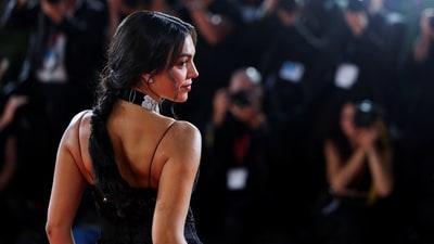 For her hair, she tied the tresses in a messy, centre-parted braided hairdo. Lastly, for the glam, she chose darkened brows, glossy mauve lips, winged eyeliner, mascara-adorned lashes, rouge-tinted cheeksm, and beaming highlighter.&nbsp; (REUTERS)