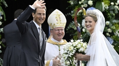 Princess Marie Caroline of Liechtenstein was all smiles as she arrived for her wedding with Leopoldo Maduro Vollmer at Cathedral St. Florin in Vaduz. She was accompanied by her father, Hereditary Prince Alois of Liechtenstein, and Bishop Benno Elbs, who also joined in the moment. (Walter Bieri/Keystone via AP) (AP)