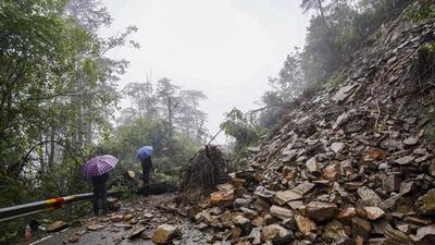 People walking past debris following a landslide in the Ramnagar area of Shimla on Monday. (PTI Photo) People walking past debris following a landslide in the Ramnagar area of Shimla on Monday. (PTI Photo)