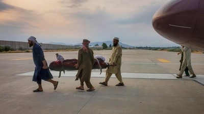 An earthquake victim is carried on a stretcher to an ambulance at an airport in Afghanistan's Jalalabad after an earthquake jittered the eastern part of the country on Monday. (REUTERS)
