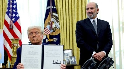 President Donald Trump holds an executive order about tariffs increase, flanked by Commerce Secretary Howard Lutnick, in the Oval Office in Feburary. President Donald Trump holds an executive order about tariffs increase, flanked by Commerce Secretary Howard Lutnick, in the Oval Office in Feburary.