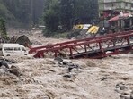 A vehicle stuck in Manalsu drain, flowing in spate, after heavy monsoon rain, at Manali in Kullu district, Himachal Pradesh, on Tuesday. (PTI) A vehicle stuck in Manalsu drain, flowing in spate, after heavy monsoon rain, at Manali in Kullu district, Himachal Pradesh, on Tuesday. (PTI)