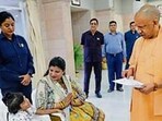 Chief minister Yogi Adityanath meets Mayra and her mother at Janata Darshan in Lucknow on Monday. (HT) Chief minister Yogi Adityanath meets Mayra and her mother at Janata Darshan in Lucknow on Monday. (HT)