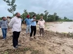 DC Himanshu Jain inspects a breached embankment in Khaira Bet village on Monday. (HT Photo)