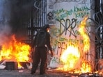 A protester sets fire to the gate of the regional parliament building in Bandung, West Java province, Indonesia, during a protest against the government's spending priorities, such as enhanced perks for lawmakers.